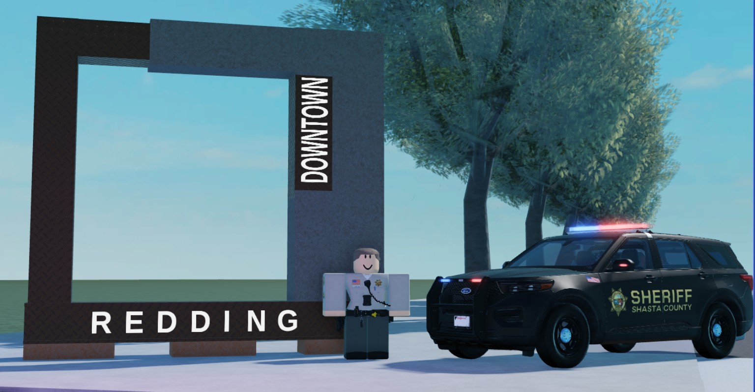 Project Shasta County development screenshot showing a Shasta County Sheriff SUV and Roblox deputy beside a Downtown Redding sign